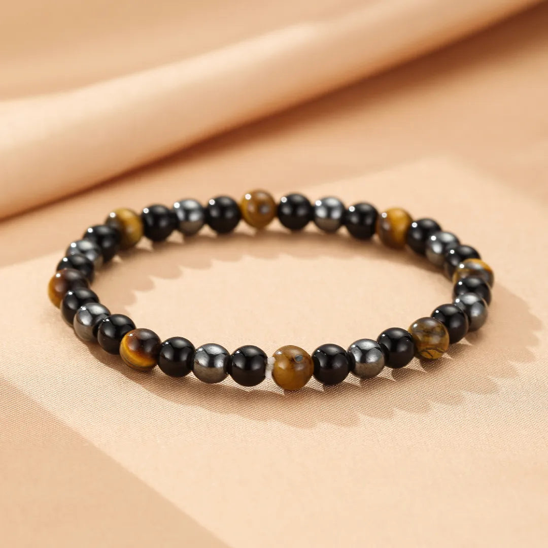 Bracelet unisexe en œil de tigre et hématite, perles alternées, style minimaliste, pour la protection et la force.